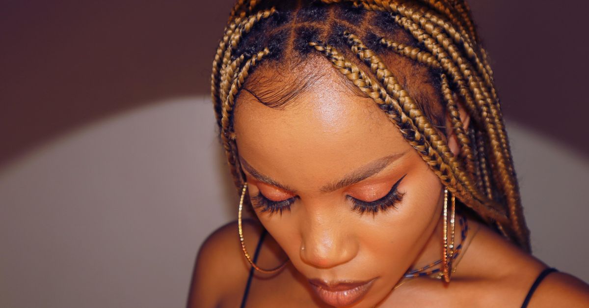 Close-up of a woman with braids showing her hairline and edges