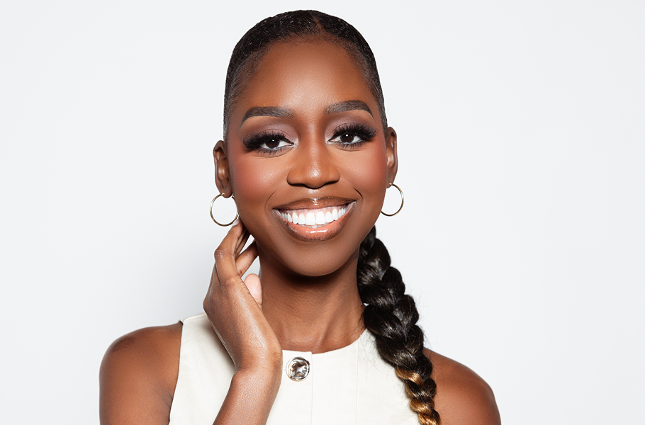Smiling woman showcasing a sleek, professional braided ponytail for the Braid Miracle hair care brand.