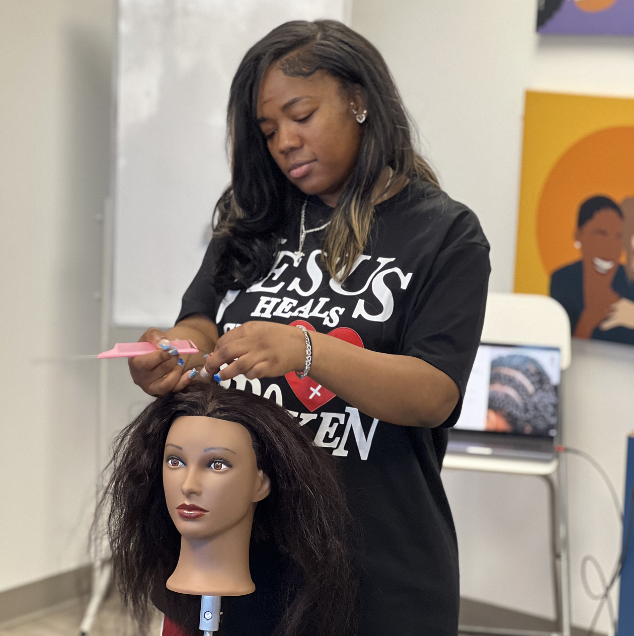 Participant learning braiding techniques in Braids for Good