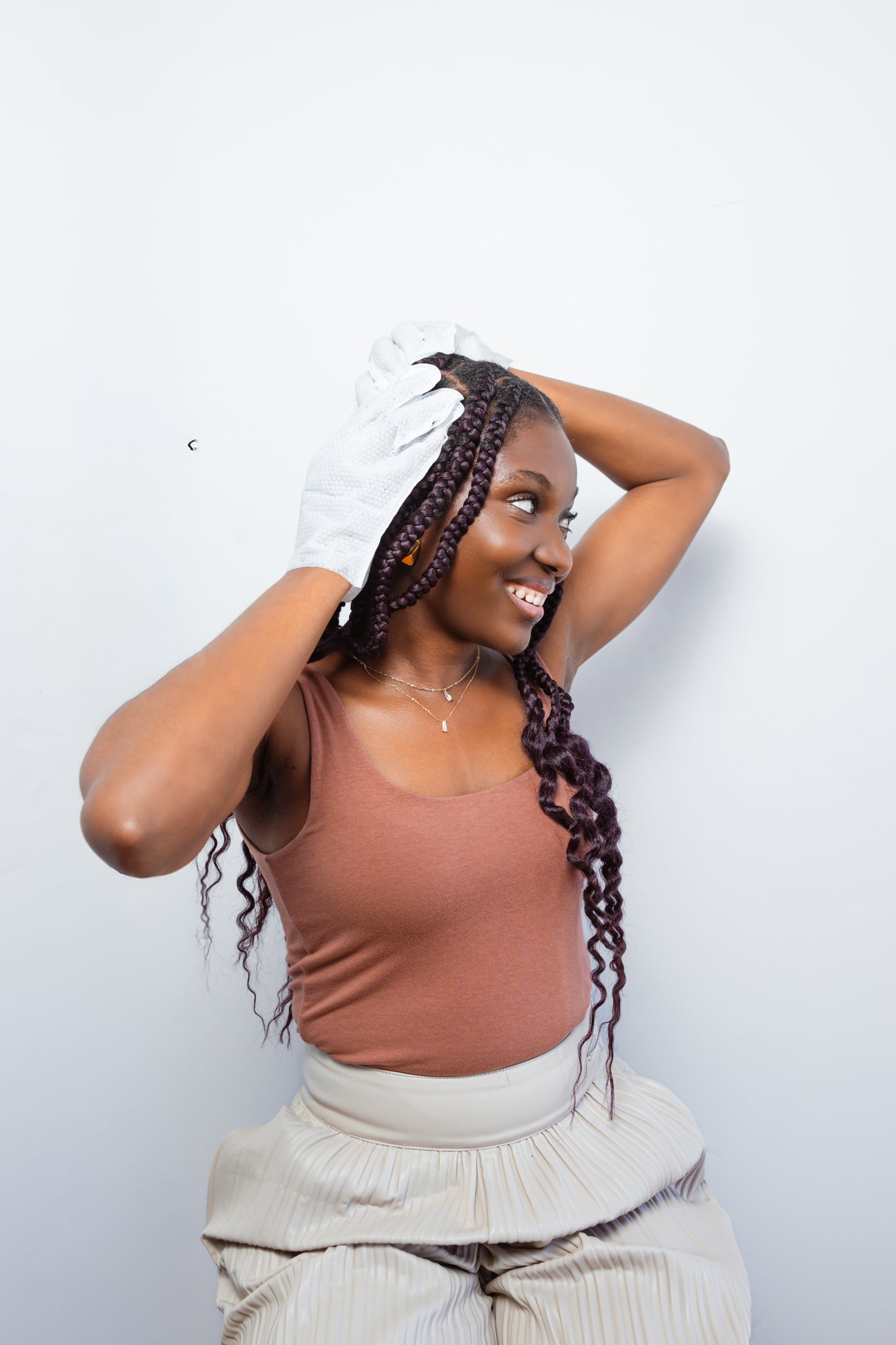 Woman with braids demonstrating scalp care